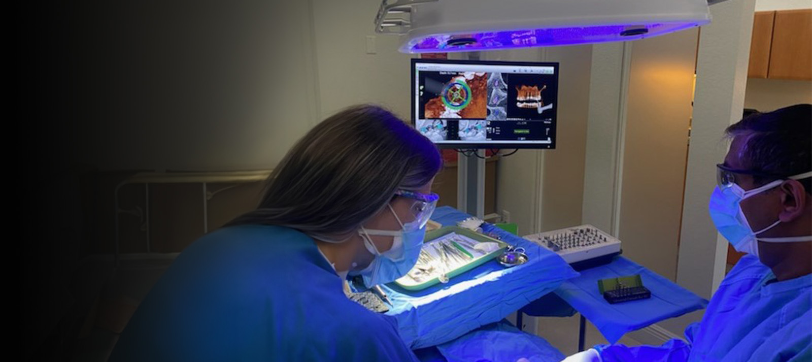 An image of a medical setting with a person in blue scrubs operating an ophthalmic machine, likely during a surgical procedure.