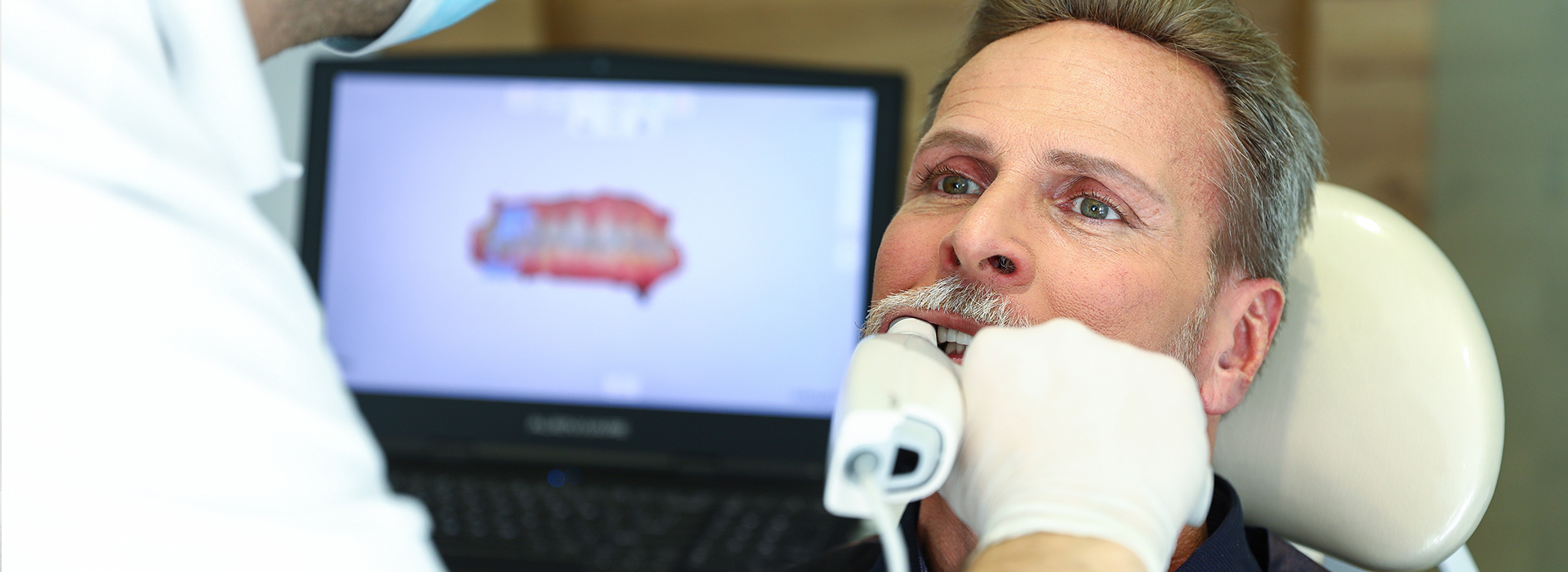 An image of a dental professional performing a procedure on a patient in a dental office setting.