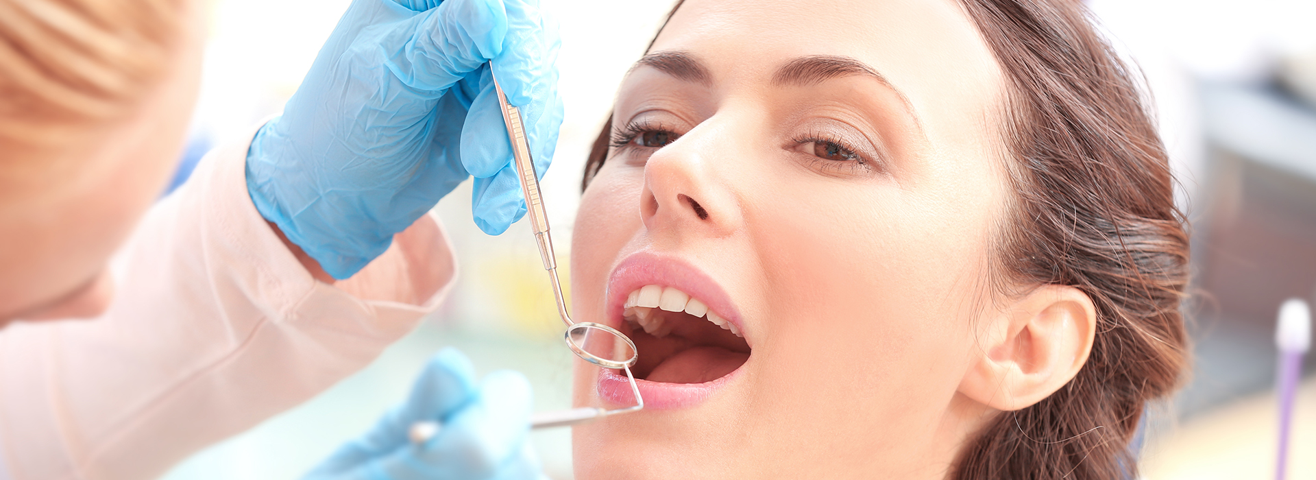 Woman receiving dental implant treatment with a dentist.