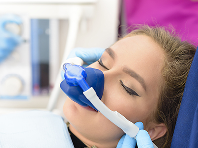 A woman receiving oxygen therapy in a medical setting.